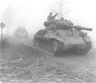 tank destroyers advance through the foggy Ardennnes December 1944