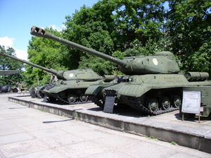 IS-2 model 1943 (front) and IS-3 at the Great Patriotic War Museum, Minsk, Belarus. The KV series of Soviet heavy tanks was criticized by their crews for their low mobility, and lack of any heavier armament than the T-34 medium tank. In 1942, this problem was partially addressed by the lighter, faster KV-1S tank. The KV series remained much more expensive than the T-34, without having greater combat performance. The heavy tank program was nearly cancelled by Stalin in 1943. However, the German employment of large numbers of Panther and Tiger tanks at the Battle of Kursk in the summer of 1943 changed Soviet priorities. In response, the Soviet tank industry created the stopgap KV-85, and embarked on the KV-13 design program to create a tank with more advanced armour layout and a more powerful main gun. Because Marshal Kliment Voroshilov had fallen out of political favour, the new heavy tank series was named the Iosif Stalin tank [IS rather than KV].